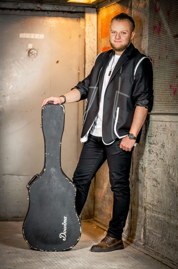 Jakub Stasikowski z futerałem na gitare